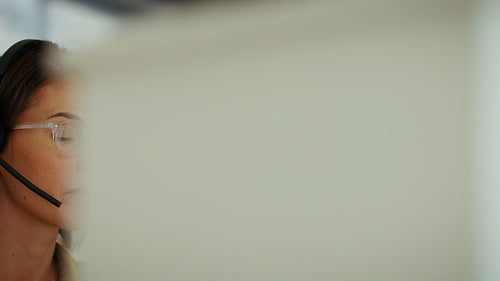 Businesswoman talking on headset in office