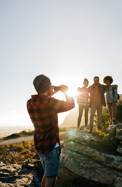 Young hikers taking pictures outdoors