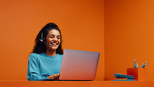 Call operator with blue colorblocking elements in a vibrant monochromatic office