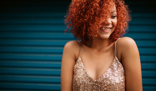 Happy young woman in glamorous dress.