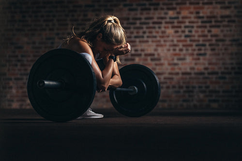 Woman smiling while exercising at fitness club