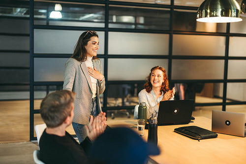 Happy business team celebrating success in creative workplace