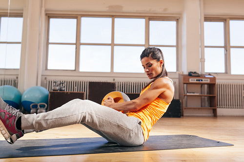 Young woman doing crossfit workout at gym