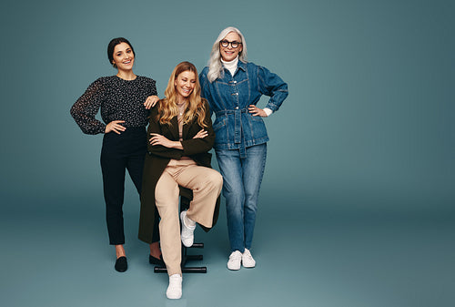 Group of three happy women smiling cheerfully