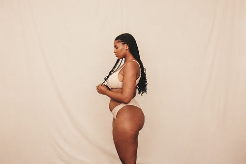 Curvy young woman wearing underwear in a studio