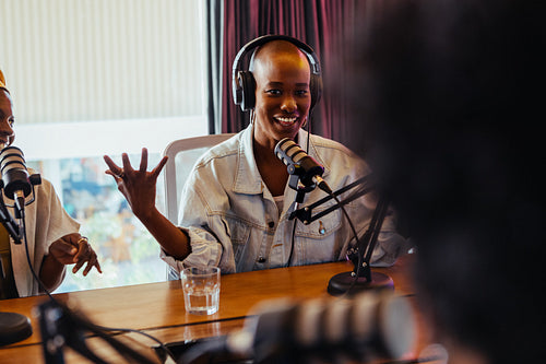 Confident young woman recording a podcast with professional equipment