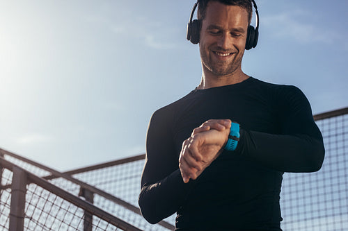 Athlete using smartwatch to monitor his progress