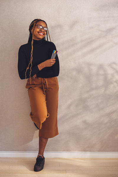 Artistic young woman standing in her home office