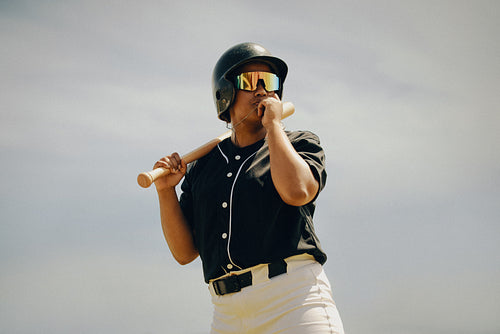 Baseball player kissing necklace for good luck before the game