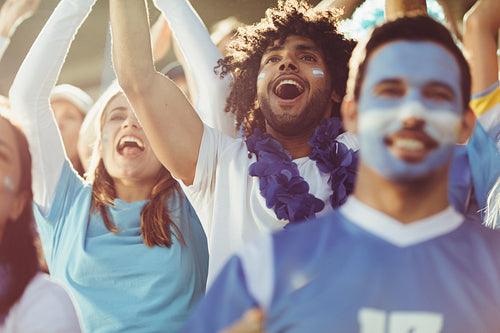 Argentinian soccer fans chanting and cheering for their team