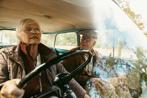 Senior couple traveling by car