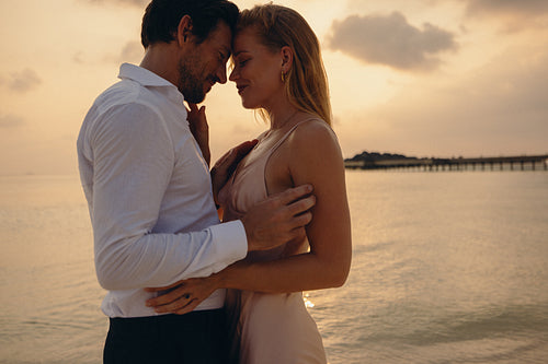 Sunset romance: Couple embracing a romantic moment on a tropical island