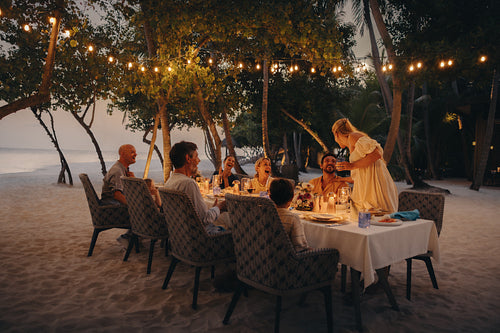 Elegant family dinner at a luxury resort during sunset