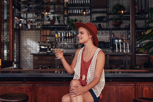 Stylish young woman having a drink at cafe