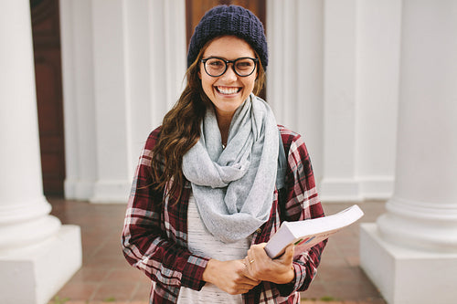 Cheerful female student at university campus