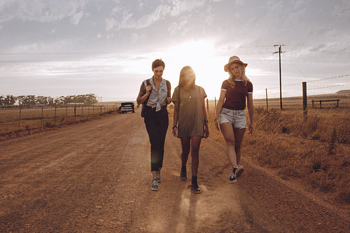 Woman on roadtrip leaving broken down car on country road