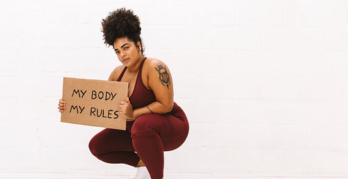 Healthy female with "My body my rules" placard