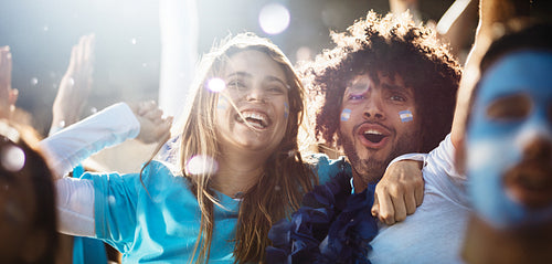 Cheering couple at football match