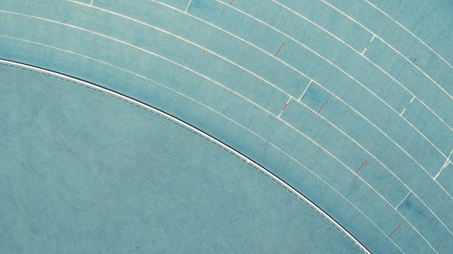 Female athlete running a victory lap with flag