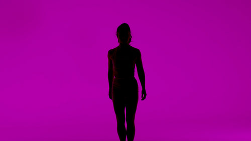 Artistic silhouette of a graceful woman performing contemporary dance on a vibrant magenta background
