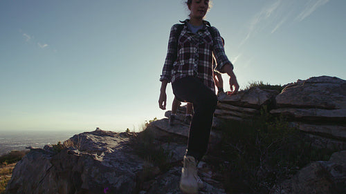 Friends hiking down a rocky mountain trail