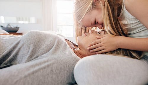 Woman sleeping on her daughter's lap