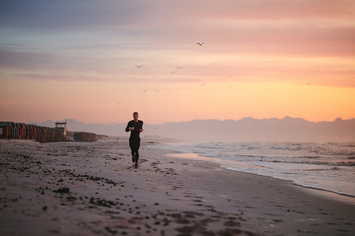 Fit male runner running on the beach