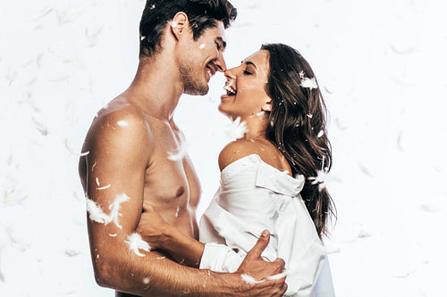 Romantic couple with feathers falling by