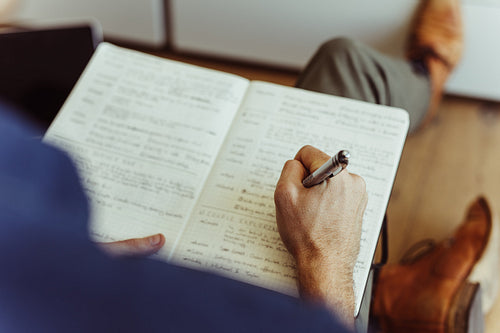 Man taking notes in his diary