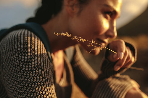Hiker relaxing with a twig