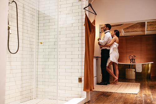Couple getting dressed in their hotel room