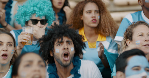 Football supporters in fan zone celebrating a goal