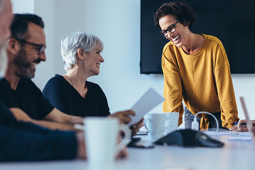 Businesspeople smiling during a meeting
