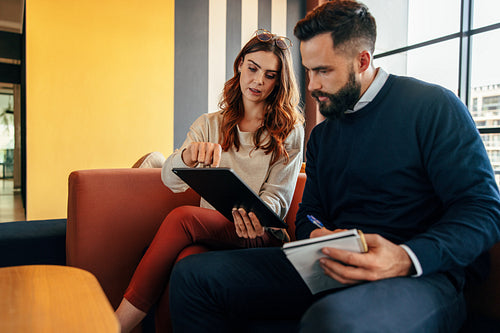 Focused businesspeople having a discussion in a lobby
