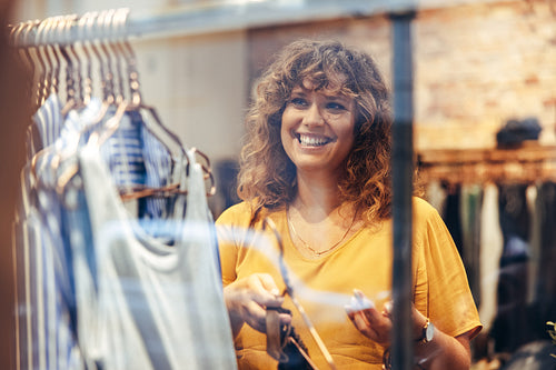 Saleswoman setting up fashion store display