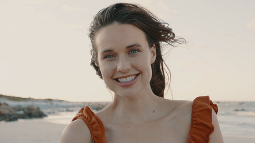 Attractive woman smiling on the beach