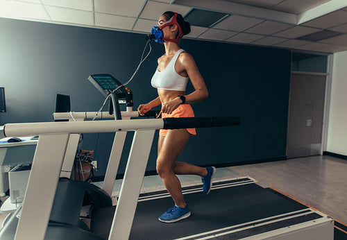 Female runner on treadmill at biomechanics lab