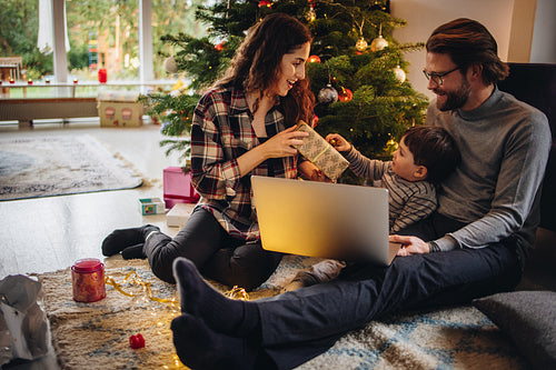 Family having fun celebrating Christmas with gifts