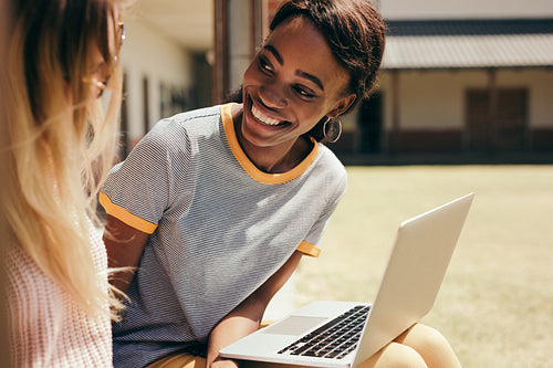Smiling female students at college campus