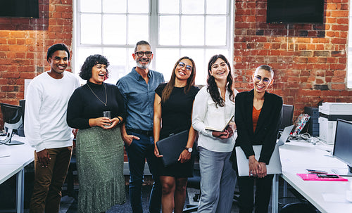 Successful businesspeople smiling in an office
