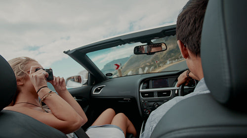 Couple taking photos on a road trip