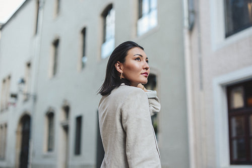 Pensive woman standing in a city street