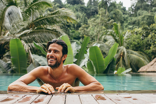 Smiling young man in swimming pool