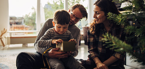 Boy having a look at his Christmas gift