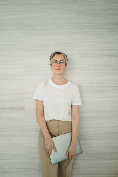 Businesswoman standing against a wall in an office