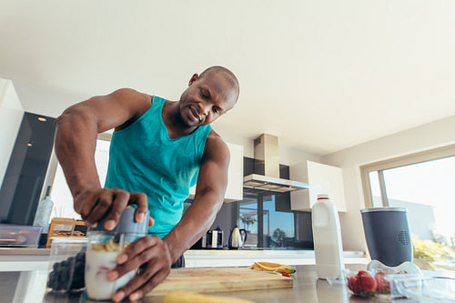 Man preparing breakfast in kitchen