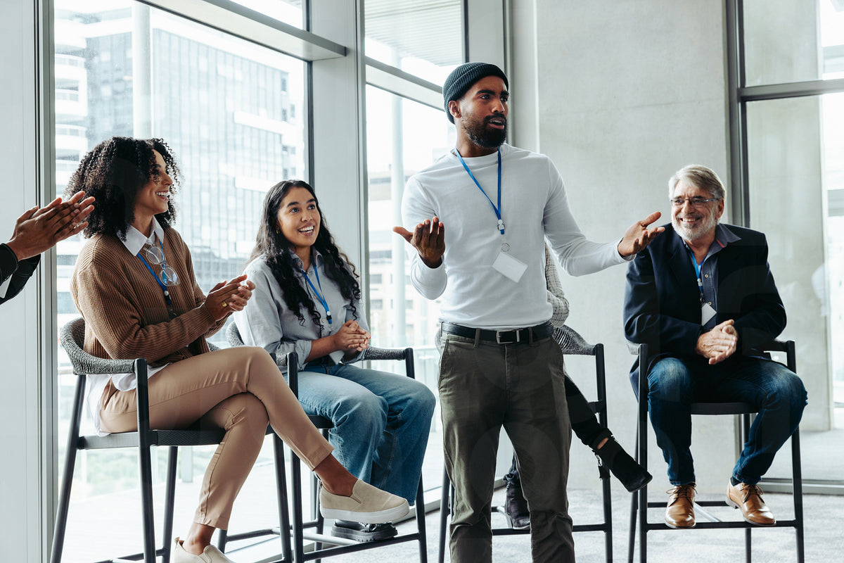 Diverse group of people engaged in a lively business meeting discussio ...
