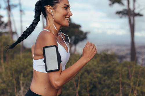 Fitness woman sprinting outdoors in morning