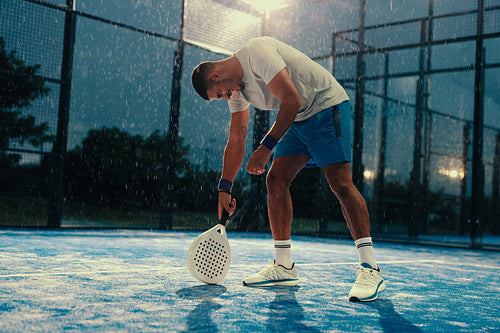 Padel player celebrating after a successful training session in the rain