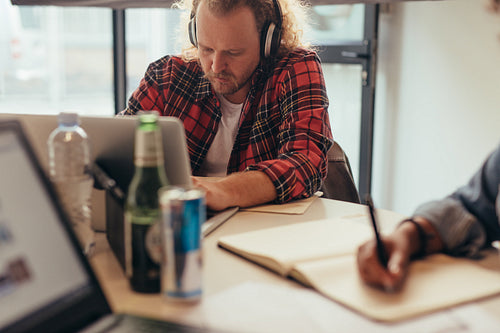 Programmer working on laptop at startup company